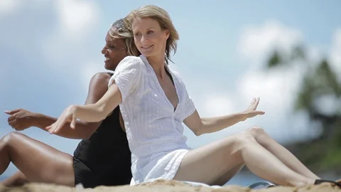 Friends dancing back to back on a beach. Video stock 88370075