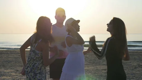 Friends dancing at the beach at sunrise Stock Footage 71379115