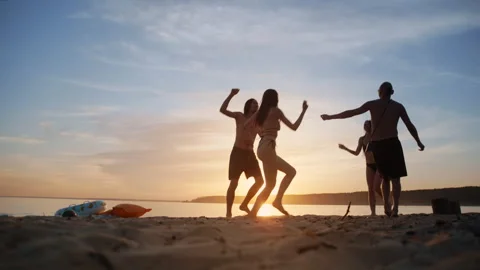 Friends dancing on the beach at sunset Stock Footage 316358968