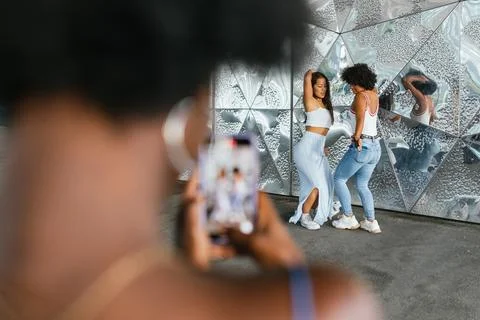 Friends dancing while recording in video with the mobile Stock Photos