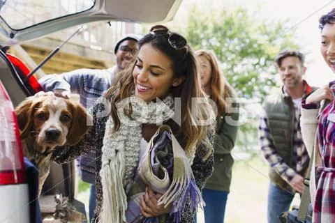 Friends with dog at back of car Stock Photos