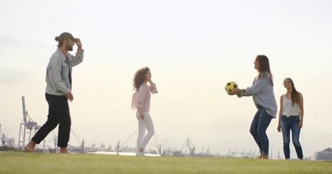 Friends doing tricks with a ball in a city park Stock Footage 84644173