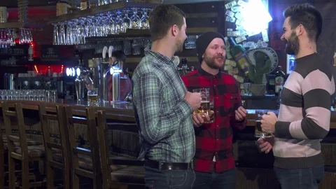 Friends drink beer at the pub Stock Footage 73717058