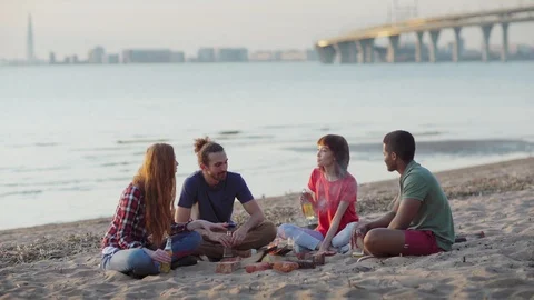 Friends drinking beer and talking near campfire Stock Footage 111593108