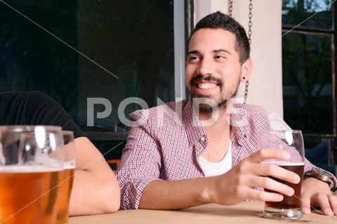 Friends drinking beer at bar Stock Photos