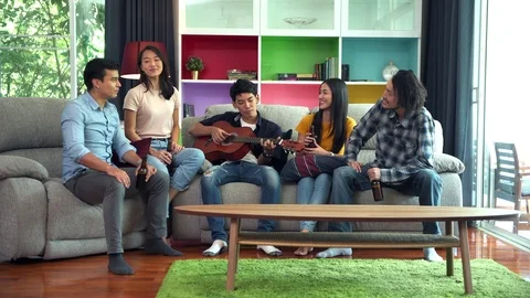 Friends drinking beers on sofa. House party. Stock Footage 99015832