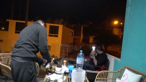 Friends drinking whiskey and making video call with their remote friend in a Stock Footage 155795482