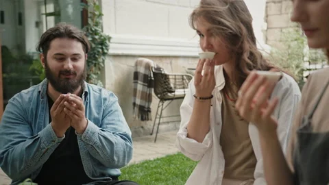 Friends during tea ceremony in backyard Stock Footage 219952041