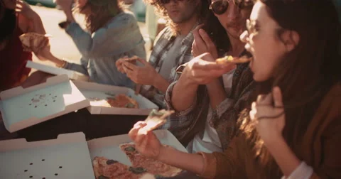 Friends eating pizza at the harbor close to their vintage van Stock Footage 61387096