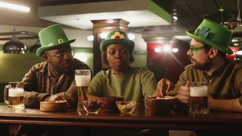 Friends Eating Snacks with Beer in Pub on St Patricks Day Stock Footage 290451655