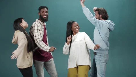 Friends embracing and having fun over green wall, dancing in casual clothes Stock Footage 170675636