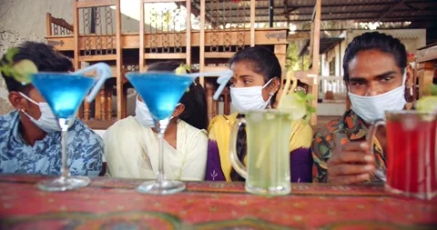 Friends in an empty bar restarant cafe with face masks Stock Footage 145116047