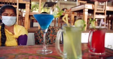 Friends in an empty bar restarant cafe with face masks Stock Footage 145116620