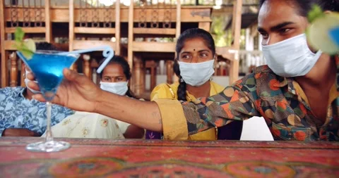 Friends in an empty bar restarant cafe with face masks Stock Footage 145117328