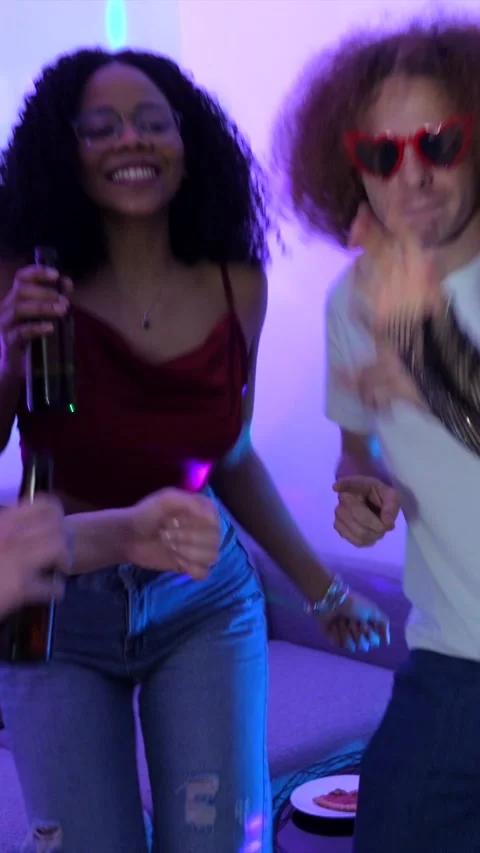 Friends enjoying drinks and dancing at home party Stock Footage 306216453