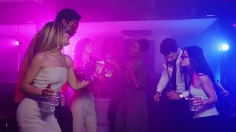 Friends enjoying drinks and dancing at nightclub party in slow motion Stock Footage 311096648
