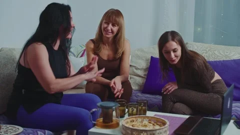 Friends enjoying an evening together while sharing laughter and stories Stock Footage 296896836