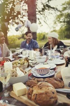Friends enjoying lunch at patio table Stock Photos