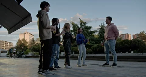 Friends Enjoying a Summer Evening: Dancing, Drinks, and Laughter Outdoors Stock Footage 312071985