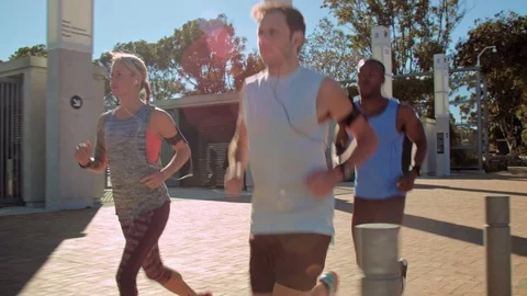 Friends exercising having a run through urban city Stock Footage 71626342