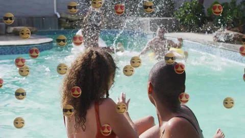 Friends floating on rings in backyard pool emoji drifting as men paddling Stock Footage 317799912