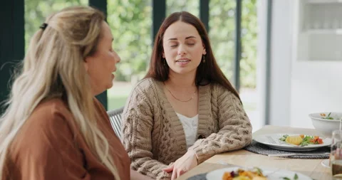 Friends, food and conversation at table in living room for holiday, event and Stock Footage 268956853