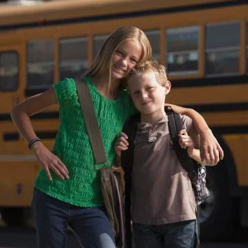Friends in front of school bus Stock Photos