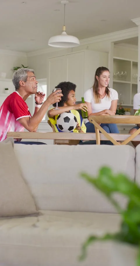 Friends gathering at dining table at home gray-haired man raising glass teen Stock Footage 345322877