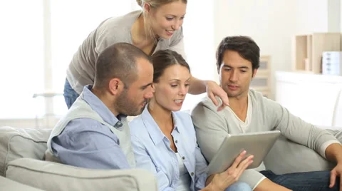 Friends gathering at home and using tablet Stock Footage 37728135