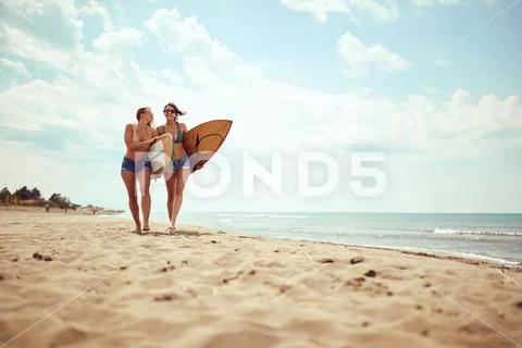 Friends girls going to surfing. Healthy Active Lifestyle.. Stock Photos