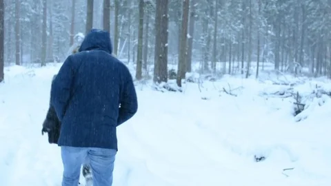 Friends go on a forest winter trail. There is heavy snow. Stock Footage 84875391