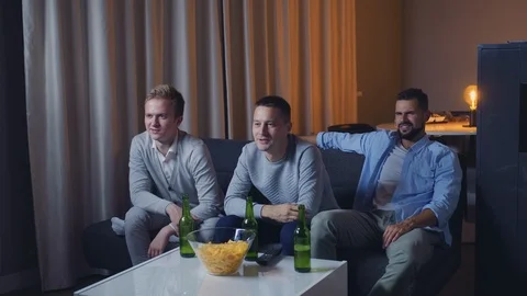 Friends group in the evening watching soccer match on TV 스톡 동영상 120618052