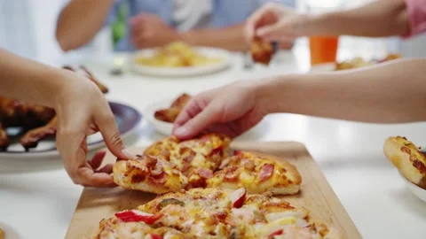 Friends group having lunch sitting around and picking up a portion at home. Stock Footage 137053612