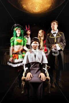 Friends at halloween party in costumes Stock Photos