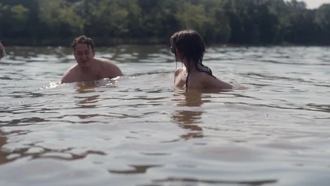 Friends hang out and float around in a forest park on a hot summer day Stock Footage 116725703