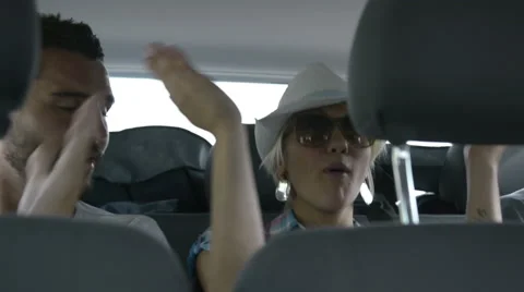 Friends have fun singing during a travel in a moving van 動画素材 64519930