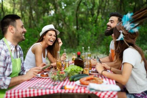 Friends having a barbecue party and fun in nature Stock Photos