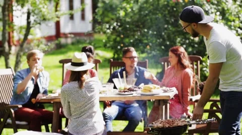 Friends having barbecue party at summer garden Stock Footage