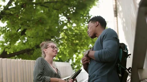Friends having a chat. Student and professor standing on stairs passage and t Stock Footage 218474587