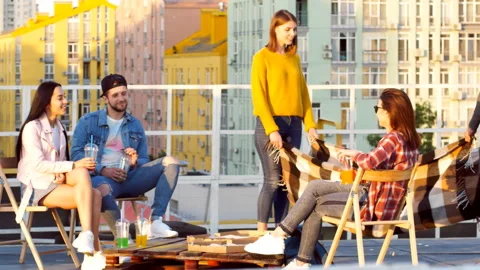 Friends having dinner or BBQ, or pizza party on rooftop. Stock Footage 112240206