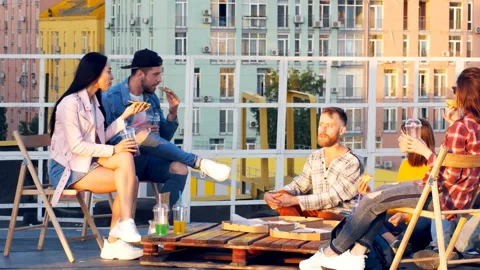 Friends having dinner or BBQ, or pizza party on rooftop. Stock Footage 112240302