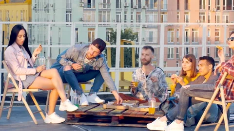 Friends having dinner or BBQ, or pizza party on rooftop. Stock Footage 112240392