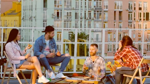 Friends having dinner or BBQ, or pizza party on rooftop. Stock Footage 112240582