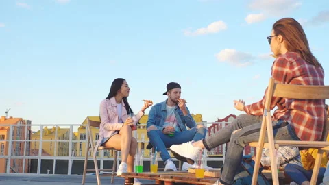 Friends having dinner or BBQ, or pizza party on rooftop. Stock Footage 112241462