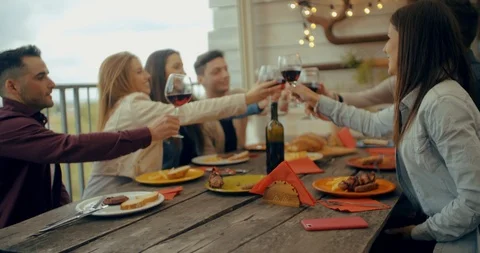 Friends having dinner together on the rooftop at home. Shot in slow motion Stock Footage 117183122
