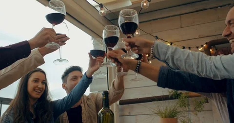 Friends having dinner together on the rooftop at home. Shot in slow motion Stock Footage 117183136