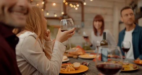 Friends having dinner together on the rooftop at home. Shot in slow motion Stock Footage 118067024