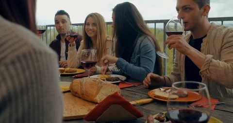 Friends having dinner together on the rooftop at home. Shot in slow motion Stock Footage 118068377