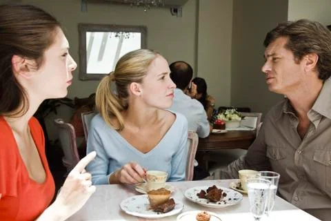 Friends having discussion at cafe Foto stock