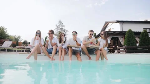 Friends having fun and enjoy their meal together in swimming poolside Stock Footage 151417515